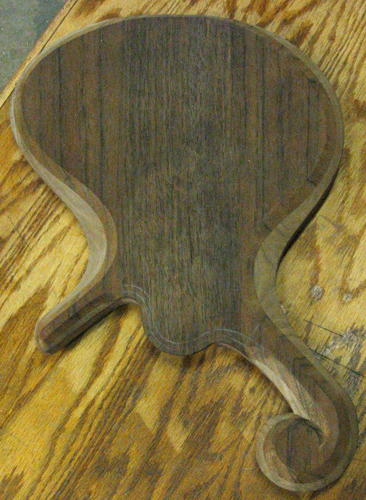 Back of the bass body. The darker black walnut contrasts with the lighter black walnut on the contours of the body.