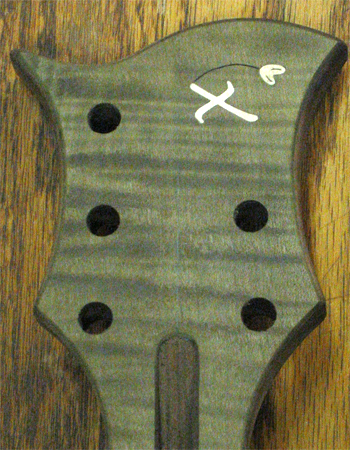 Headstock of the bass guitar with a maple Xylem logo