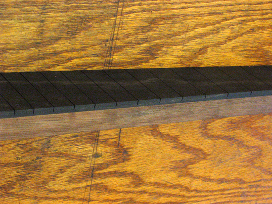 Neck with ebony fretboard glued on, before binding