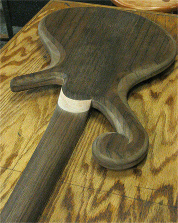 The scroll, neck heel and black walnut neck of the custom bass