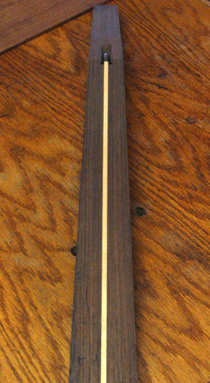 Black walnut neck with scarf joint and truss rod installed with a rock maple spline