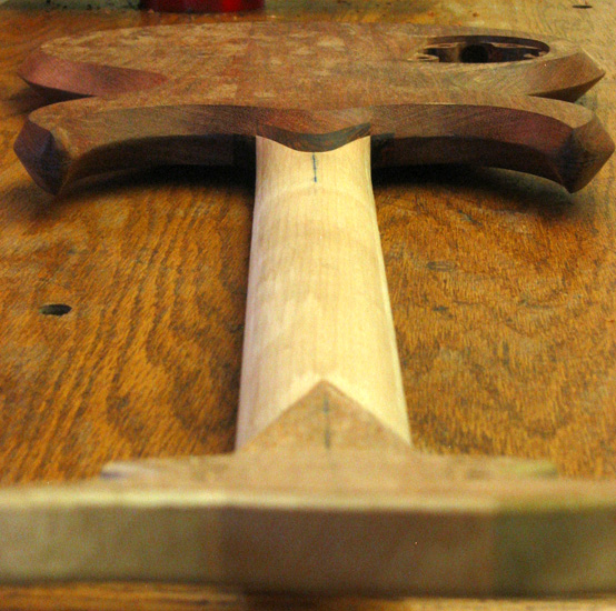 Wide angle of the guitar from the headstock showing the neck shim and contours of the horns
