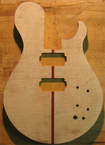 A Xylem guitar body with a flamed maple top right after cutting out the body shape