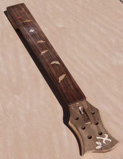 Fretboard inlay of leaves and a dogwood flower