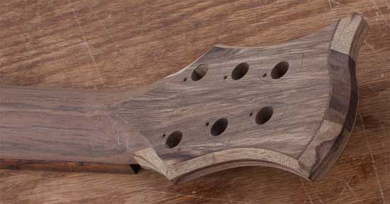 Black korina headstock of a custom guitar