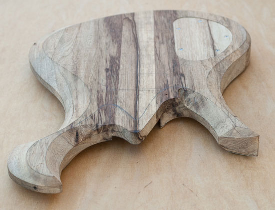 Carved black limba custom guitar body with Xylem scroll