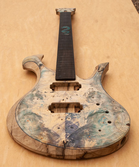 Xylem custom colored burl guitar shortly before completion