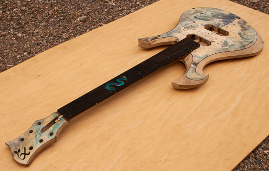 Custom guitar with ebony fretboard, walnut neck, colored burl top